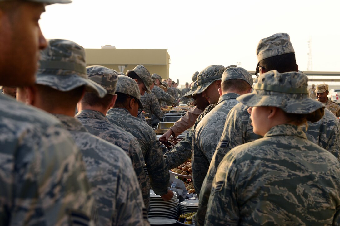 The Qatari military invited U.S. servicemembers deployed to Al Udeid Air Base, Qatar, to celebrate Qatar National Day, over breakfast, on December 18, 2014. The annual holiday is an occasion for Qataris to commemorate their national identity and history, and allows them to remember how their national unity was achieved. This year’s Qatar National Day celebration included a parade involving all branches of the Qatari military, police, and schools. The parade featured massive fire work displays, military aircraft flyovers, and many other demonstrations of national unity.  Qatar is a key and enduring regional partner of the United States.  (photo by Master Sgt. Kerry Jackson)