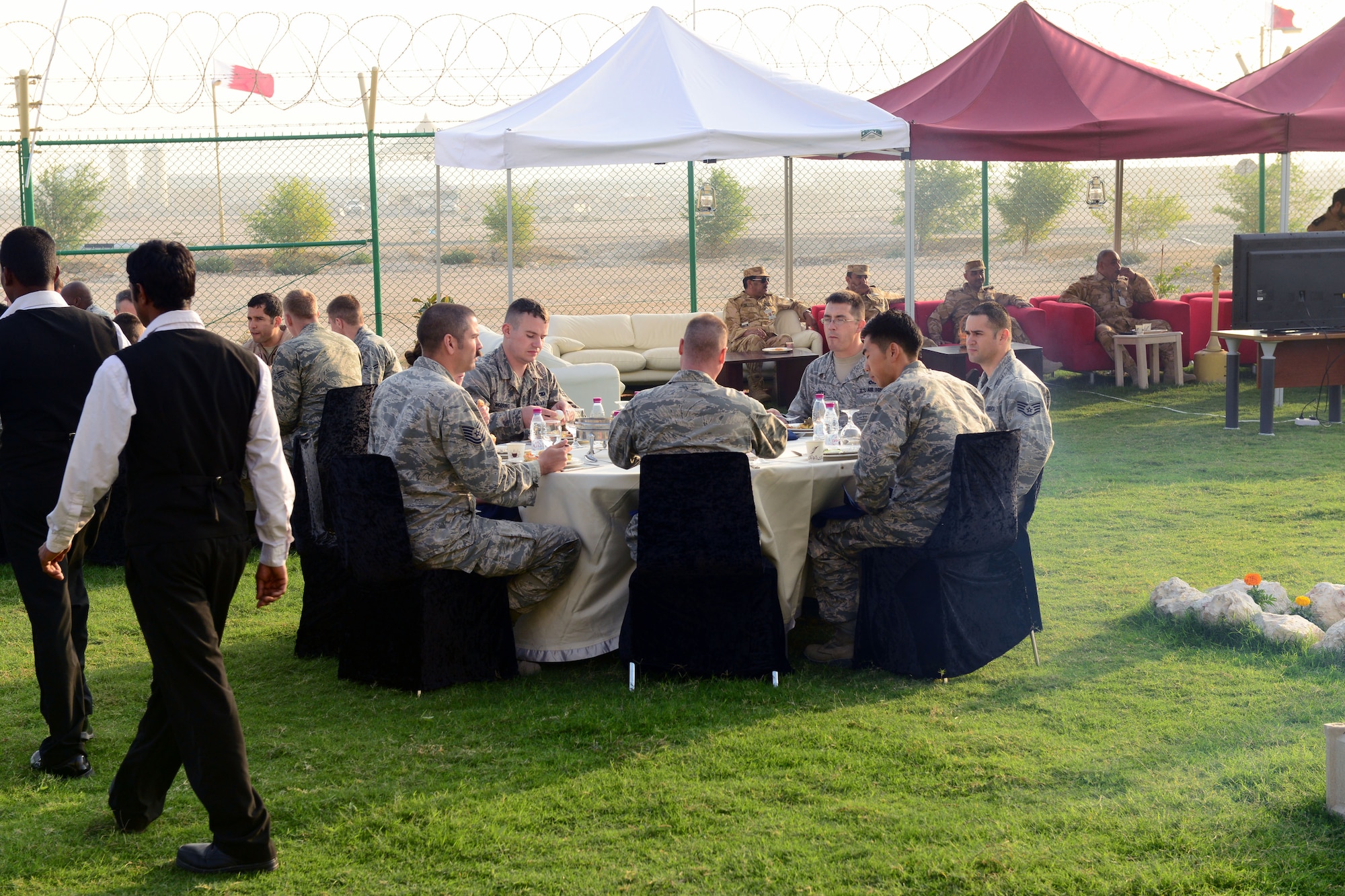 The Qatari military invited U.S. servicemembers deployed to Al Udeid Air Base, Qatar, to celebrate Qatar National Day, over breakfast, on December 18, 2014. The annual holiday is an occasion for Qataris to commemorate their national identity and history, and allows them to remember how their national unity was achieved.  This year’s Qatar National Day celebration included a parade involving all branches of the Qatari military, police, and schools. The parade featured massive fire work displays, military aircraft flyovers, and many other demonstrations of national unity.  Qatar is a key and enduring regional partner of the United States.  (photo by Master Sgt. Kerry Jackson)                          