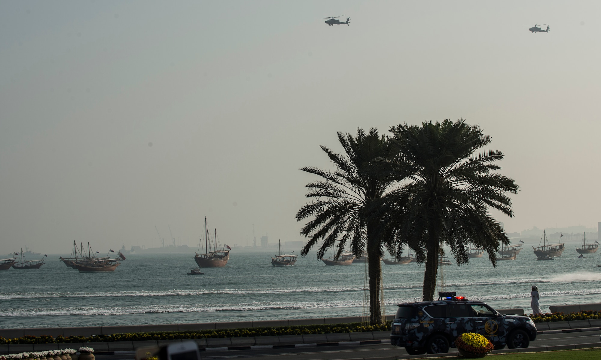 AH-64 Apache helicopters fly over a parade during the Qatar National Day, Dec. 18, 2014, in Doha,Qatar. The annual holiday is an occasion for Qataris to commemorate their national identity and history, and allows them to remember how their national unity was achieved. This year’s Qatar National Day celebration included a parade involving all branches of the Qatari military, police, and schools. The parade featured massive fire work displays, military aircraft flyovers, and many other demonstrations of national unity. Qatar is a key and enduring regional partner of the United States.(U.S. Air Force photo by Staff Sgt. Perry Aston)
