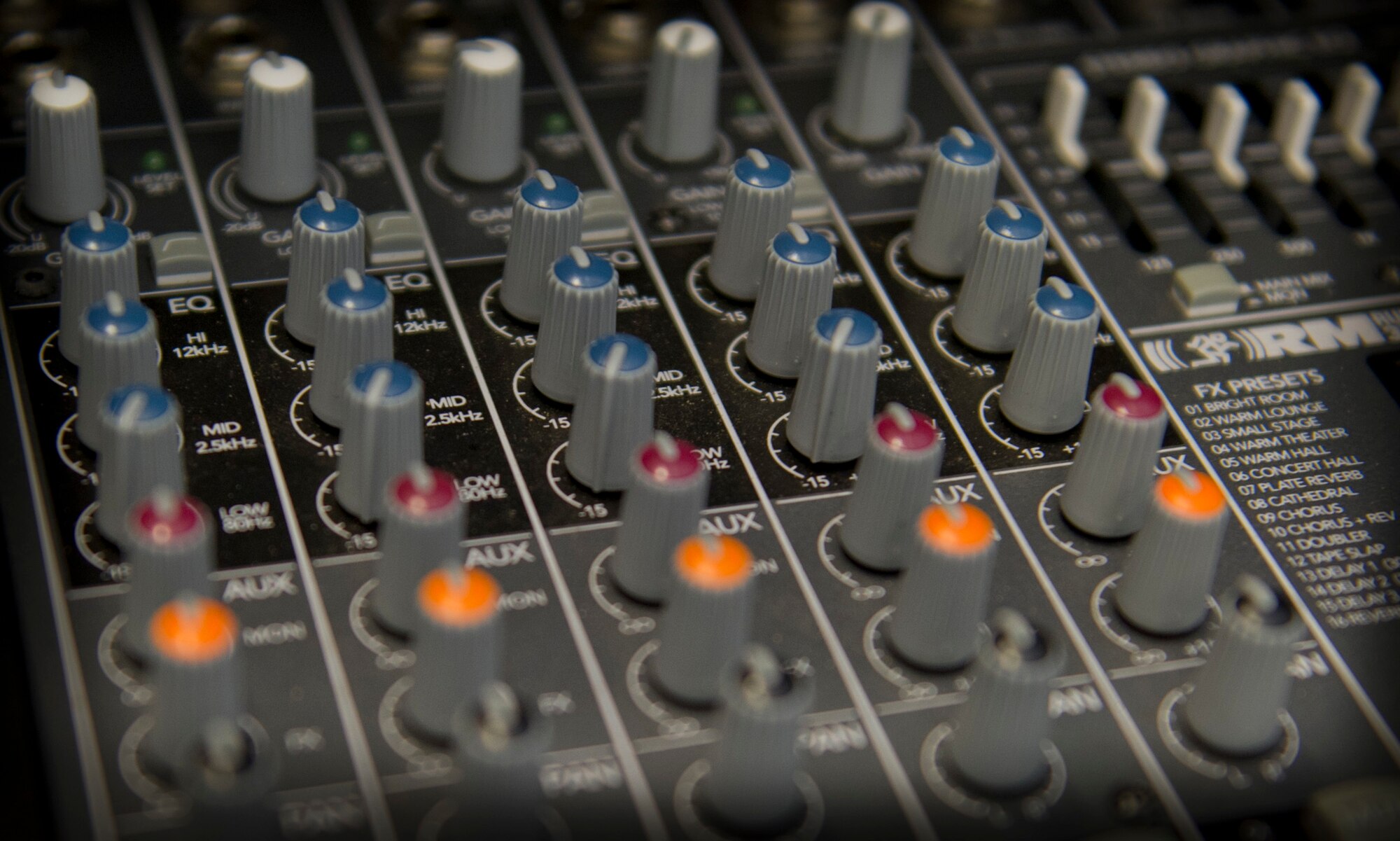 Airmen from the 1st Special Operations Communications Squadron use a sound production mixer for an awards ceremony at the Freedon Hangar on Hurlburt Field,Fla., Dec. 16, 2014. A sound production mixer allows volume control and other control access during an event. (U.S. Air Force photo/Senior Airman Krystal M. Garrett) 