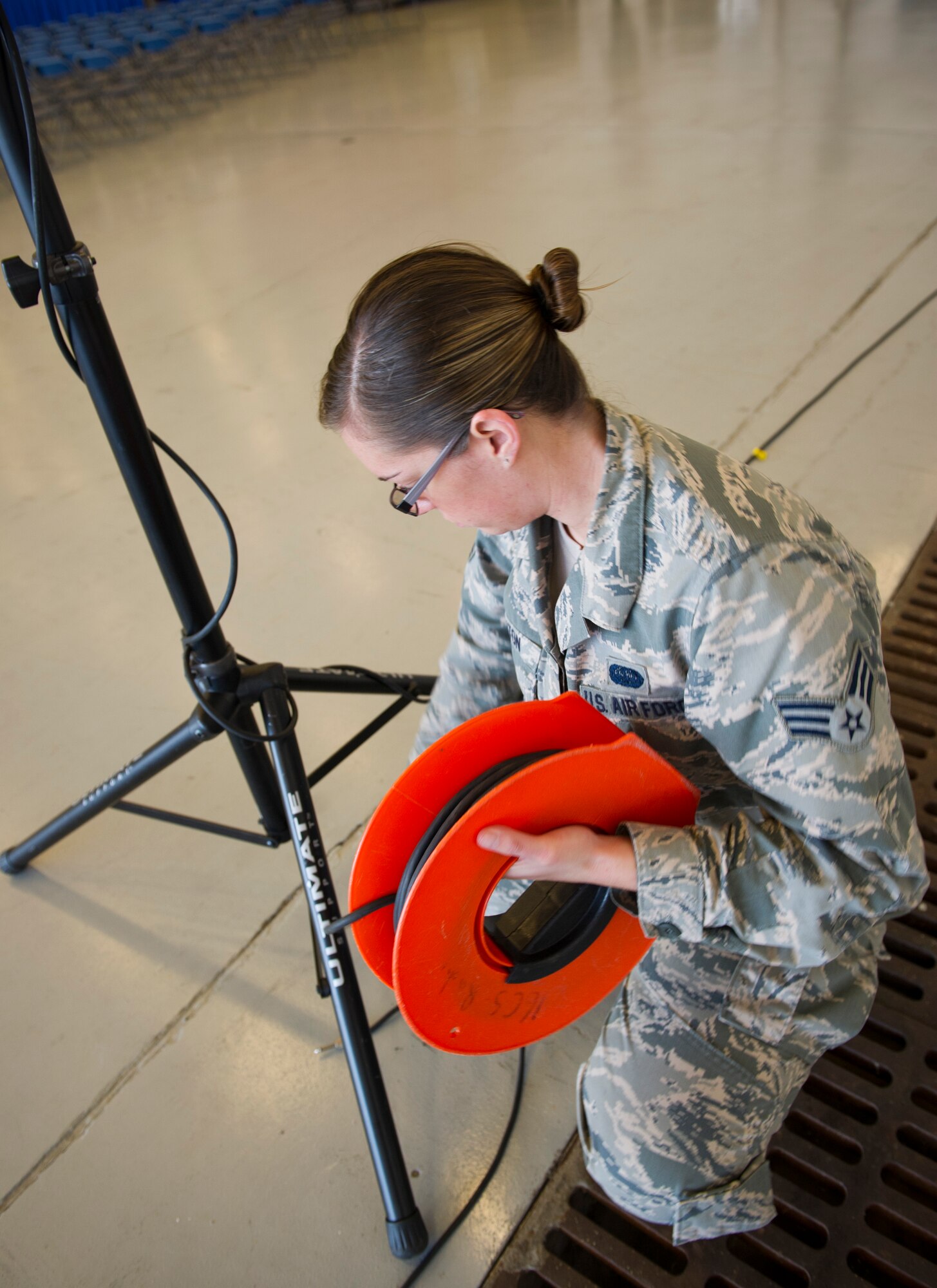 Senior Airman Amanda Dalton, 1st Special Operations Communications Squadron radio frequency transmission technician, sets up speakers for an awards ceremony at the Freedom Hangar on Hurlburt Field, Fla., Dec. 16, 2014. The 1st SOCS supports the global warfighting readiness mission by providing a full spectrum of communications via computers and radios. (U.S. Air Force photo/Senior Airman Krystal M. Garrett)