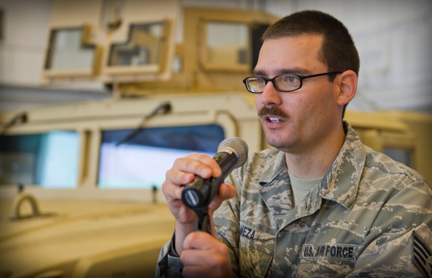 Staff Sgt. Erik Meza, 1st Special Operations Communications Squadron radio frequency transmission technician supervisor, conducts a microphone check for an awards ceremony at the Freedom Hangar on Hurlburt Field, Fla., Dec. 16, 2014. A microphone check is done to ensure the quality of the speaker systems and the volume of the speaker is sufficient. (U.S. Air Force photo/Senior Airman Krystal M. Garrett) 