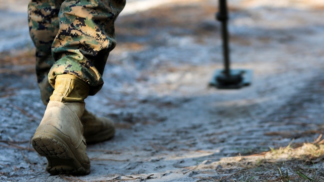 A combat engineer with 2nd Combat Engineer Battalion uses a metal detector to search for possible simulated improvised explosive devices during a route clearance exercise at training area GE aboard Camp Lejeune, Dec. 15, 2014. Marines with 2nd CEB and Explosive Ordnance Disposal Company, 8th Engineer Support Battalion worked together to clear a route of mock IEDs using tools, such as metal detectors, Talon robots, Huskies and Buffaloes.