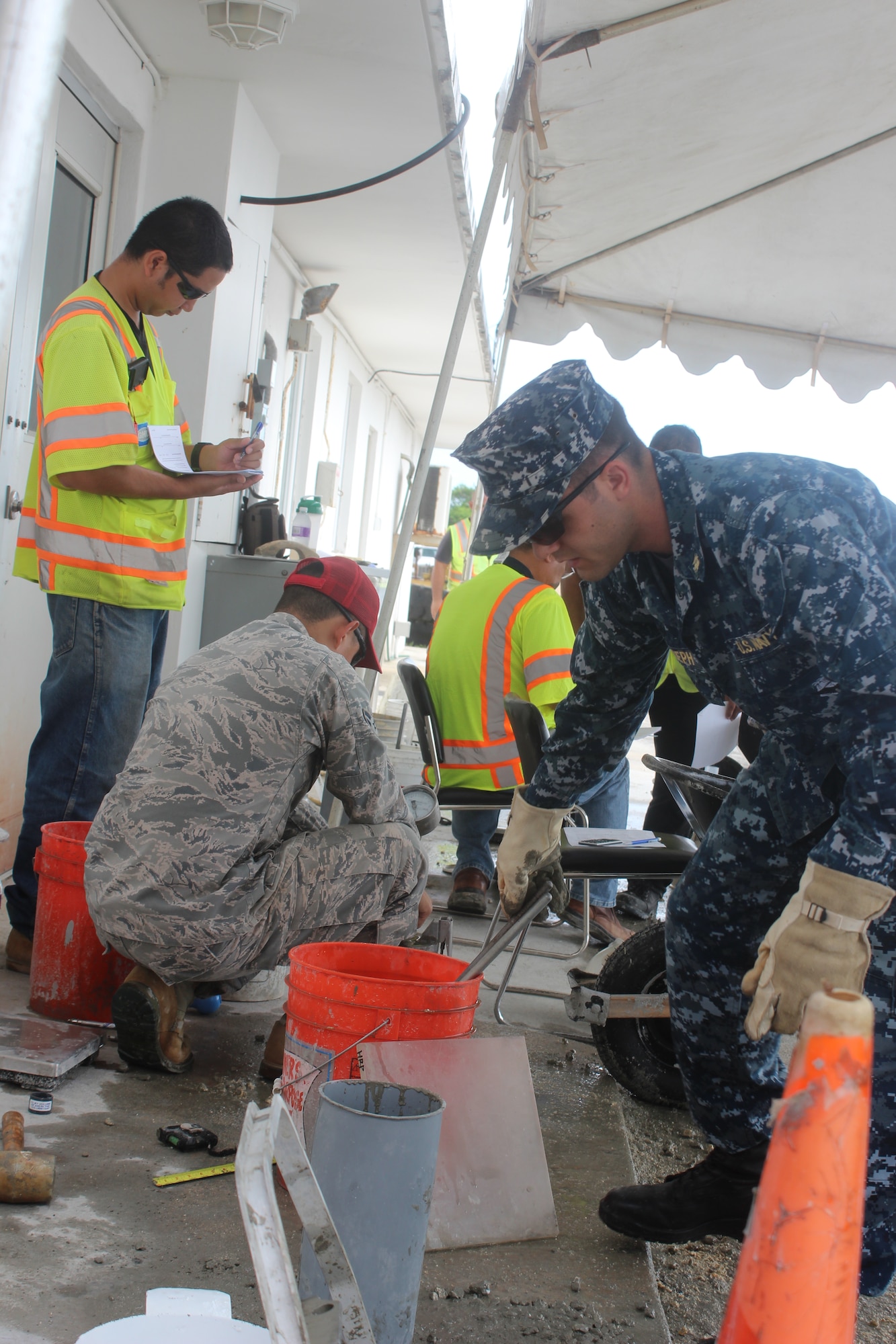 U.S. Navy Lt. j.g. Christopher Joseph tests concrete with Airman 1st Class Manuel Jimenez during a training course Dec. 11, 2014, in Mangilao, Guam. Military members and civilians recently completed a series of two-day courses to learn concrete field testing processes and procedures. Joseph is a Naval Base Guam assistant production officer and Jimenez is a 554th RED HORSE Squadron engineer assistant. (U.S. Air Force photo/Capt. Naseem Ghandour)