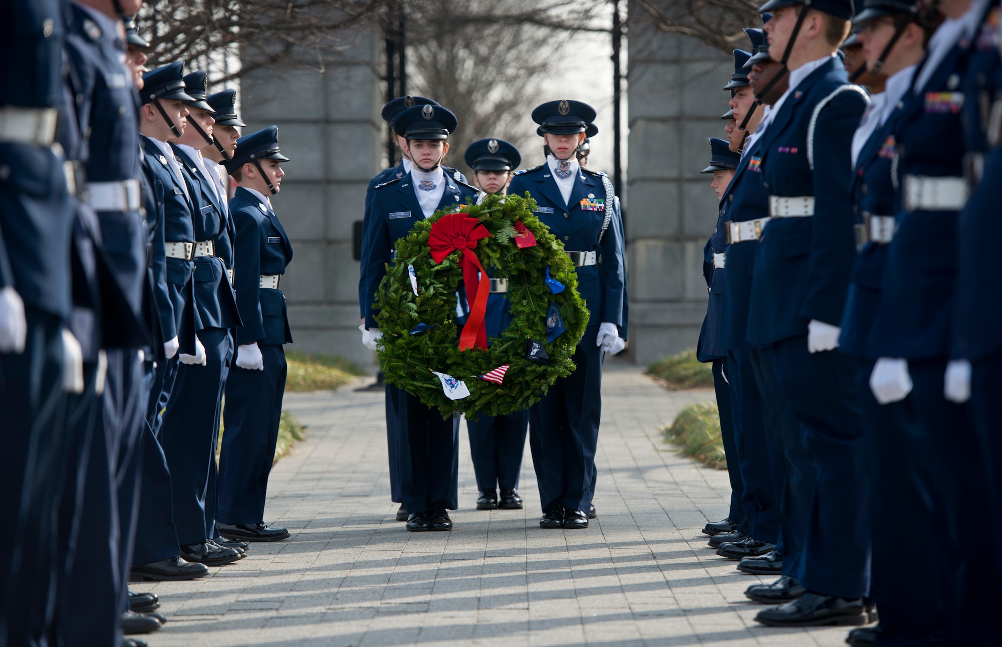 Civil Air Patrol cadets carry a wreath to be placed at a grave marker Dec. 13, 2014, during Wreaths Across America at Arlington National Cemetery in Arlington, Va. Nearly 50,000 volunteers came together to place remembrance wreaths on the headstones of about 230,000 veterans during the event. (U.S. Air Force photo/Staff Sgt. Vernon Young Jr.)
