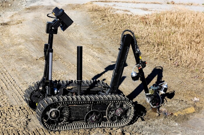 A Talon robotics platform moves a simulated improvised explosive device from the roadway during a field training exercise conducted by Explosive Ordnance Disposal Company, 8th Engineer Support Battalion, Dec. 12, 2014, at Home Station Training Lanes in Holly Ridge, N.C. EOD technicians controlled the robot from a distance to ensure the safety of the team members. (U.S. Marine Corps photo by Lance Cpl. Kirstin Merrimarahajara/released)