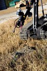 A Talon robot drops a block of C-4 on a simulated improvised explosive device to destroy the main charge by explosion.  Explosive ordnance disposal technicians use robots to find, move, and dispose of IEDs from a safe distance. (U.S. Marine Corps photo by Lance Cpl. Kirstin Merrimarahajara/released)
