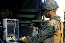 Sgt. Paul Faucheux, an explosive ordnance technician with Explosive Ordnance Disposal Company, 8th Engineer Support Battalion and a New Orleans native, uses an operational control unit to maneuver a Talon robot during a simulated post-blast analysis call during a field exercise at EOD site 3 on Camp Lejeune, N.C., Dec. 15, 2014. EOD techs used the Talon to search for possible improvised explosive devices from a safe distance. (U.S. Marine Corps photo by Lance Cpl. Kirstin Merrimarahajara/released)