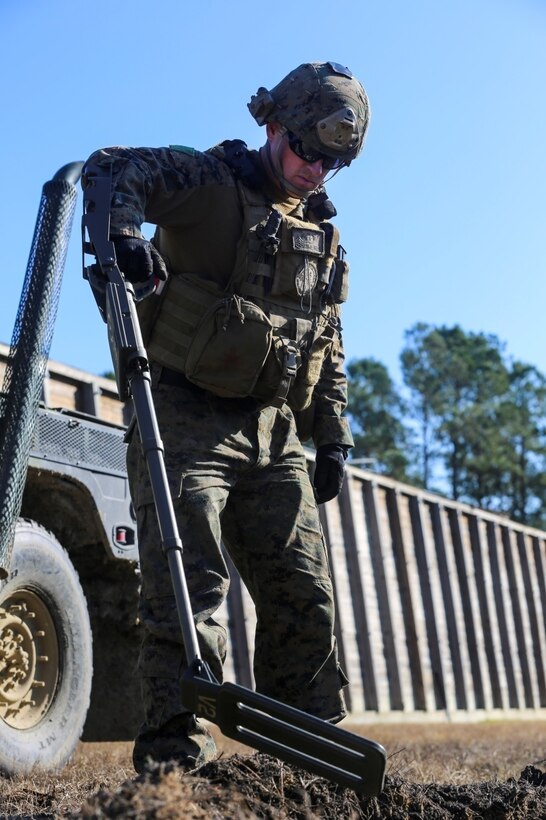 Staff Sgt. Mike Hill, an explosive ordnance disposal technician with Explosive Ordnance Disposal Company, 8th Engineer Support Battalion and a Groveland, Mass., native, uses a metal detector to search a blast seat for any evidence or explosive hazards, during a post-blast analysis call, during a training exercise at EOD site 3 aboard Camp Lejeune, N.C., Dec. 15, 2014. EOD techs use evidence found to recognize trends. Technicians found no evidence during this call. (U.S. Marine Corps photo by Lance Cpl. Kirstin Merrimarahajara/released)