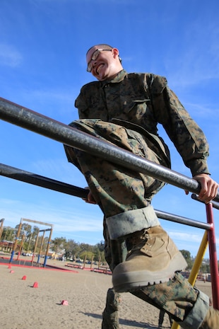 Recruits of Company L, 3rd Recruit Training Battalion maneuver through the Monkey Bridge exercise included in the Confidence Course at Marine Corps Recruit Depot San Diego, Nov. 28. In between exercises, recruits practiced Marine Corps Martial Arts Program techniques learned to help them develop muscle memory.