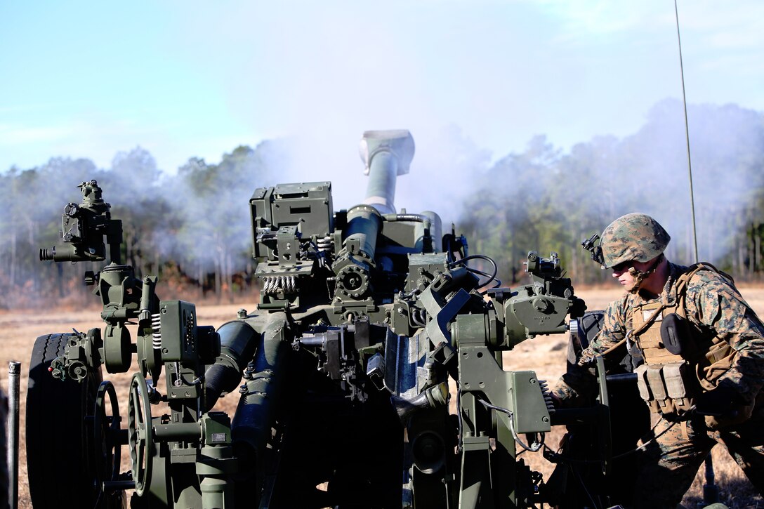 Cpl. Cole Haldeman, field artillery cannoneer, Battery A, Ground Combat Element Integrated Task Force, fires an M777 A2 howitzer during a live-fire exercise at Range GP 7 aboard Marine Corps Base Camp Lejeune, North Carolina, Dec. 17, 2014. From October 2014 to July 2015, the Ground Combat Element Integrated Task Force will conduct individual and collective skills training in designated combat arms occupational specialties in order to facilitate the standards based assessment of the physical performance of Marines in a simulated operating environment performing specific ground combat arms tasks. (U.S. Marine Corps photo by Cpl. Paul S. Martinez/Released)