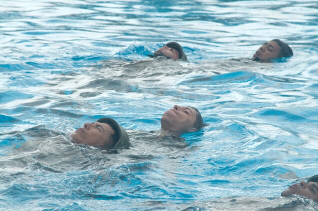 Marines training in the Marine Combat Instructor of Water Survival course drill rescues with their classmates at the Marine Corps Base Hawaii pool, Dec. 12, 2014. A total of 18 Marines were tested this week. (U.S. Marine Corps photo by Christine Cabalo/Released)
