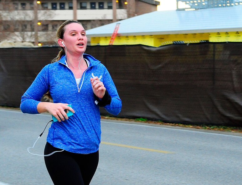 1st Lt. Kasey Vaughn, Air Force Life Cycle Management Center intelligence analyst, listens to music during the Jingle Bell 5K Fun Run on Hurlburt Field, Fla., Dec. 19, 2014. Vaughn traveled from Eglin Air Force Base to participate in the run, and came in second place in the female category. (U.S. Air Force photo/Airman 1st Class Andrea Posey)