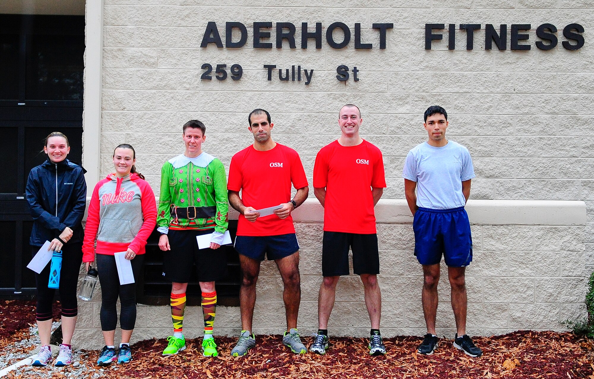 First through third place winners in the male and female categories of the Jingle Bell 5K Fun Run collect their prizes at the Aderholt Fitness Center on Hurlburt Field, Fla., Dec. 19, 2014. All six runners won gift certificates to local businesses. (U.S. Air Force photo/Airman 1st Class Andrea Posey)