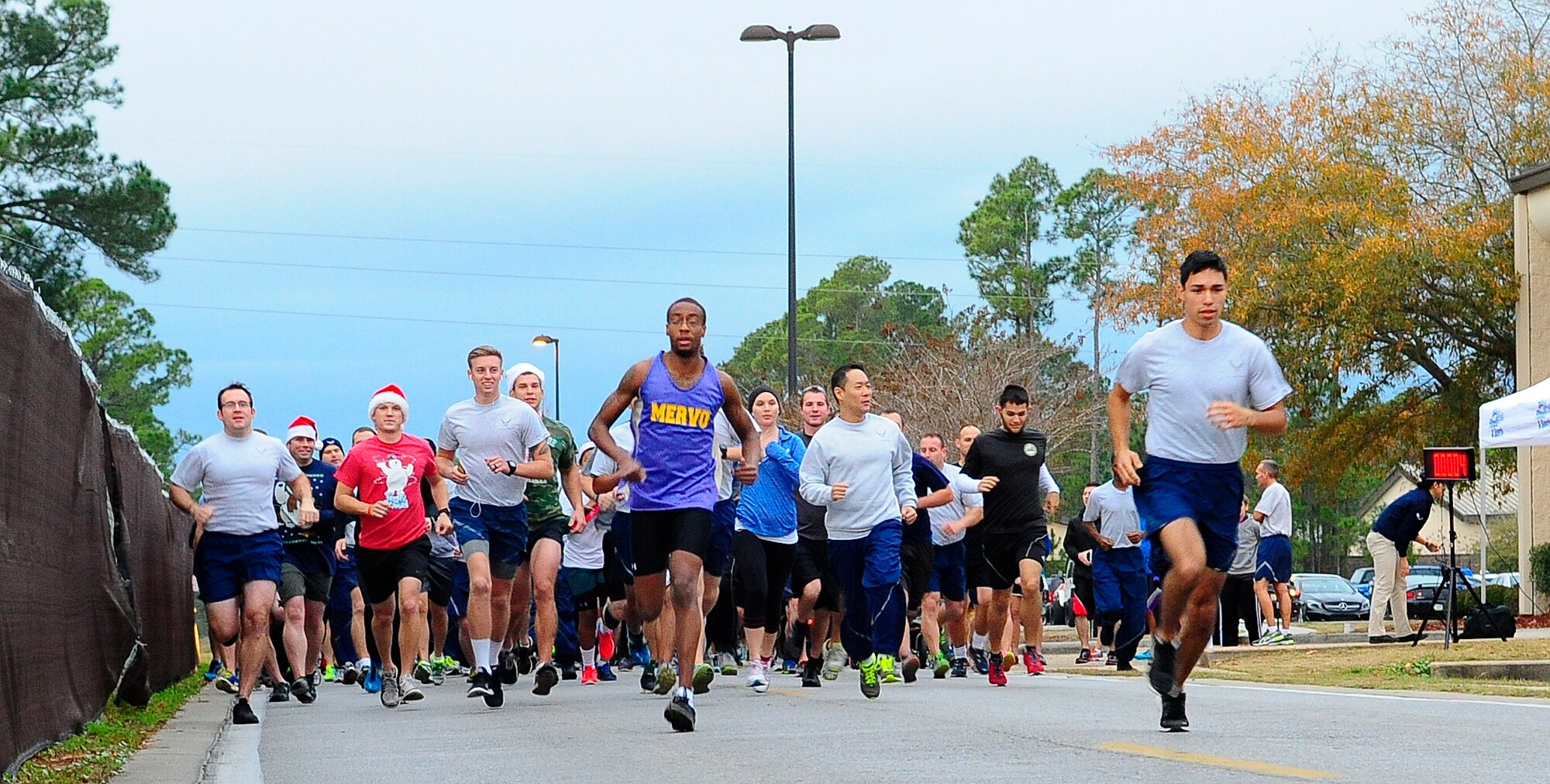 Air Commandos begin the Jingle Bell 5K Fun Run near the Aderholt Fitness Center on Hurlburt Field, Fla., Dec. 19, 2014. The event offered Airmen a chance to win gift cards and holiday hams. (U.S. Air Force photo/Airman 1st Class Andrea Posey)