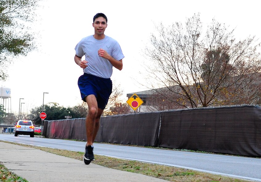 Airman 1st Class Luis Martinez Ramirez, 1st Special Operations Civil Engineer Squadron power production apprentice, finishes the Jingle Bell 5K Fun Run on Hurlburt Field, Fl., Dec. 19, 2014. Martinez finished in first place in the male category. (U.S. Air Force photo/Airman 1st Class Andrea Posey)