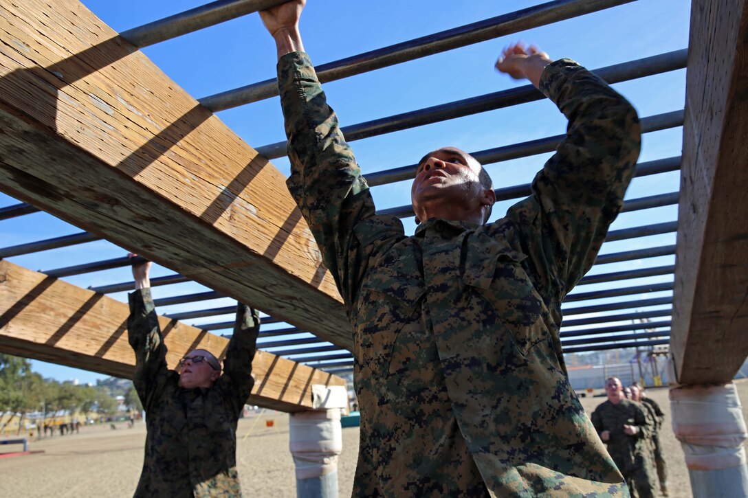 Recruits of Charlie Company, 1st Recruit Training Battalion, maneuver over the monkey bars exercise at Marine Corps Recruit Depot San Diego, Nov. 28. If recruits fell from the monkey bars exercise they had to start the exercise from the beginning. 