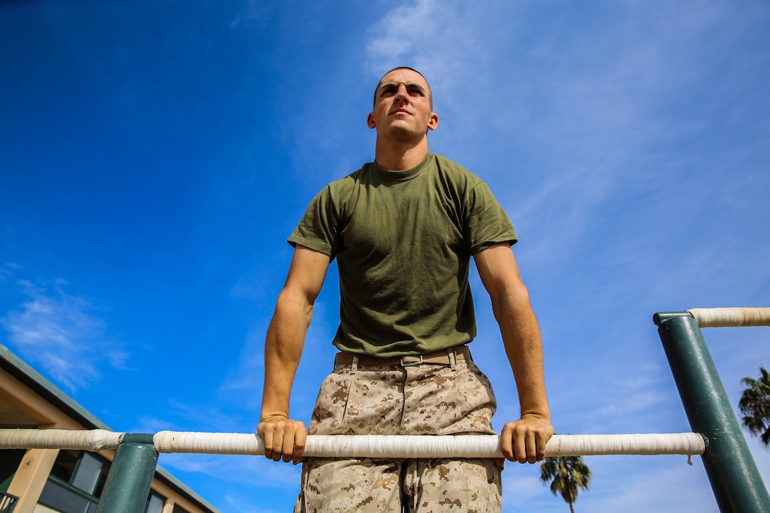 Lance Cpl. Zachary V. Maderak, Platoon 2151, Golf Company, 2nd Recruit Training Battalion, completes a muscle-up after finishing the Confidence Chamber at Marine Corps Base Camp Pendleton, Calif., Dec. 8. Maderak tested different career options before realizing he wanted nothing more than to be a Marine. He worked hard to fulfill his dream and is graduating both company honorman and most physically fit out of his peers