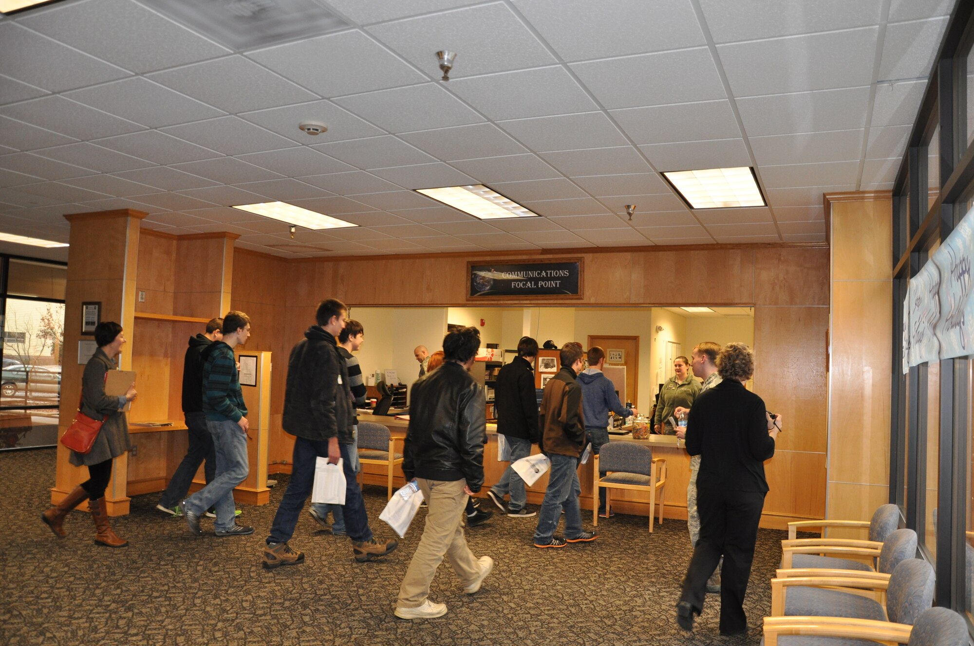 Local high school computer programming and robotics students receive a briefing from Senior Airman Alexis Waddell, 92nd Communications Squadron communications focal point operator, during a tour of the 92nd Communications Squadron Dec. 10, 2014, at Fairchild Air Force Base, Wash. The students visited the communications focal point, knowledge management, radio frequency transmissions, network administration, network infrastructure, client systems team, information assurance and communication security offices. The students also saw a demonstration of the mobile giant voice and some of the robots used by the 92nd Civil Engineer Squadron explosive ordnance disposal flight. (Courtesy photo)
