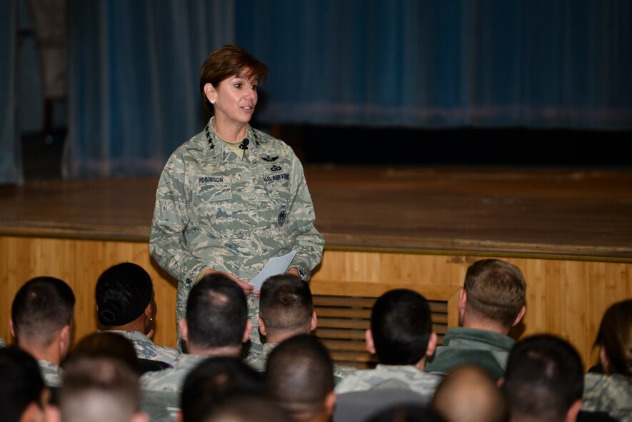 Gen. Lori Robinson, Pacific Air Forces commander, speaks to a crowd of Airmen at an all-call Dec. 19, 2014, at Osan Air Base, Republic of Korea. Robinson detailed her prime priorities during the session: taking care of Airmen and their families and accomplishing the mission. (U.S. Air Force photo by Staff Sgt. Jake Barreiro)