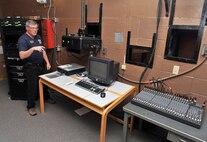 Tom Kiernan, 341st Force Support Squadron chief of Youth Programs, demonstrates new audiovisual equipment Dec. 16 at the base auditorium at Malmstrom Air Force Base, Mont. A new sound board, digital projector, remotely retractable screen, and new amplifiers and spotlights are among the recent upgrades replacing technology and wiring that was installed more than 15 years ago. (U.S. Air Force photo/John Turner)