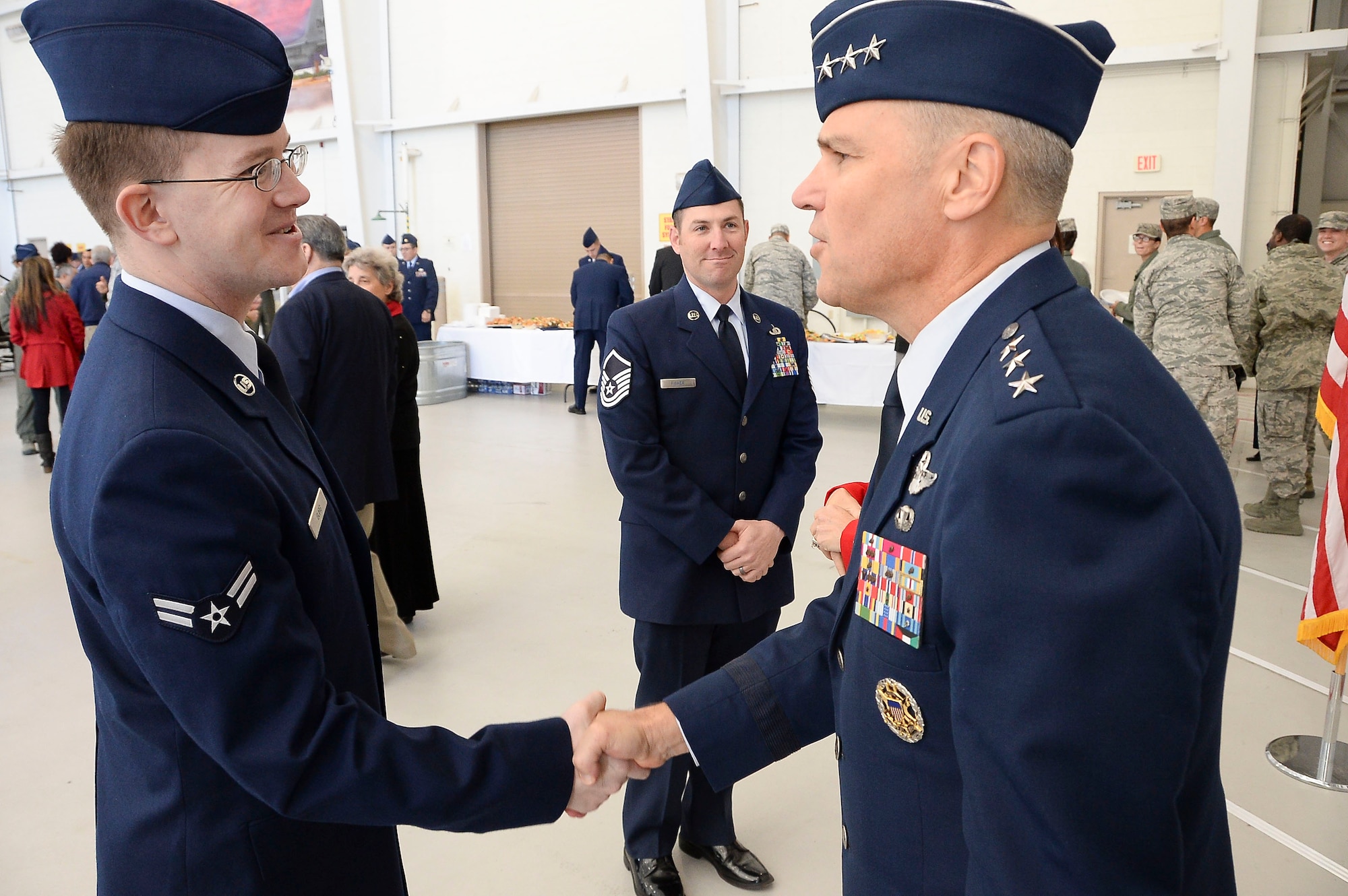 Lt. Gen. Chris Nowland, 12th Air Force (Air Forces Southern) commander, shakes hands with Airmen after assuming command of 12th Air Force (Air Forces Southern) at Davis-Monthan AFB, Ariz., Dec. 19, 2014. Nowland comes to Tucson from his previous assignment as the Chief of Staff, Headquarters United States Southern Command, where he was responsible for successfully integrating and synchronizing the efforts of nine directorates and 16 special staff offices in support of the Combatant Commander's Theater Campaign Plan. (U.S. Air Force photo by Staff Sgt. Adam Grant/Released)