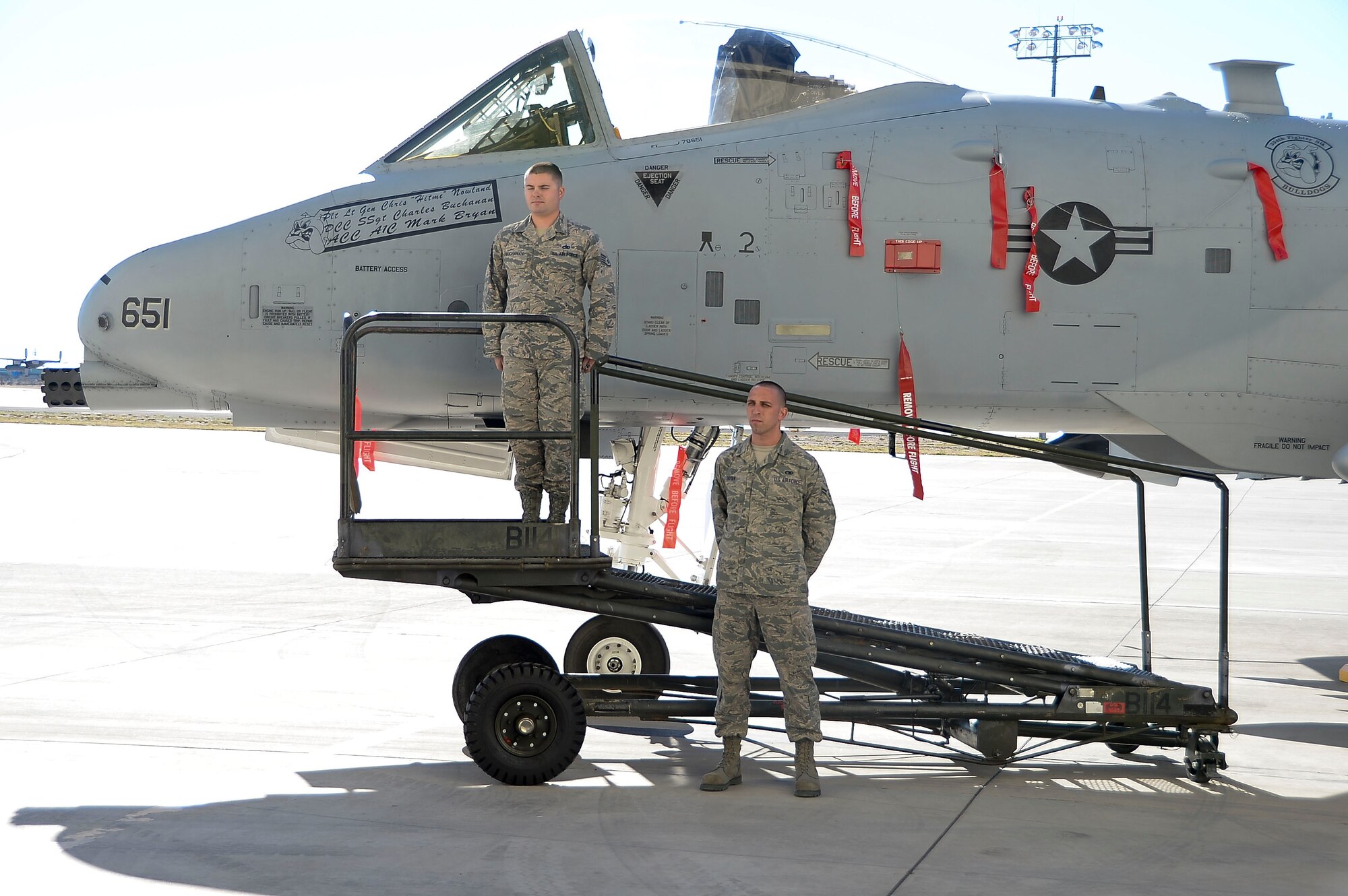 Staff Sgt. Charles Buchanan, 355th Aircraft Maintenance Squadron Dedicated Crew Chief and Airman 1st Class Mark Bryan, 355th Aircraft Maintenance Squadron Assistant Crew Chief, unveil Lt. Gen. Chris Nowland’s aircraft during the 12th Air Force (Air Forces Southern) ¬ change of command at Davis-Monthan AFB, Ariz., Dec. 19, 2014. Lt. Gen. Tod Wolters relinquished command to Lt. Gen. Chris Nowland. (U.S. Air Force photo by Staff Sgt. Adam Grant/Released)