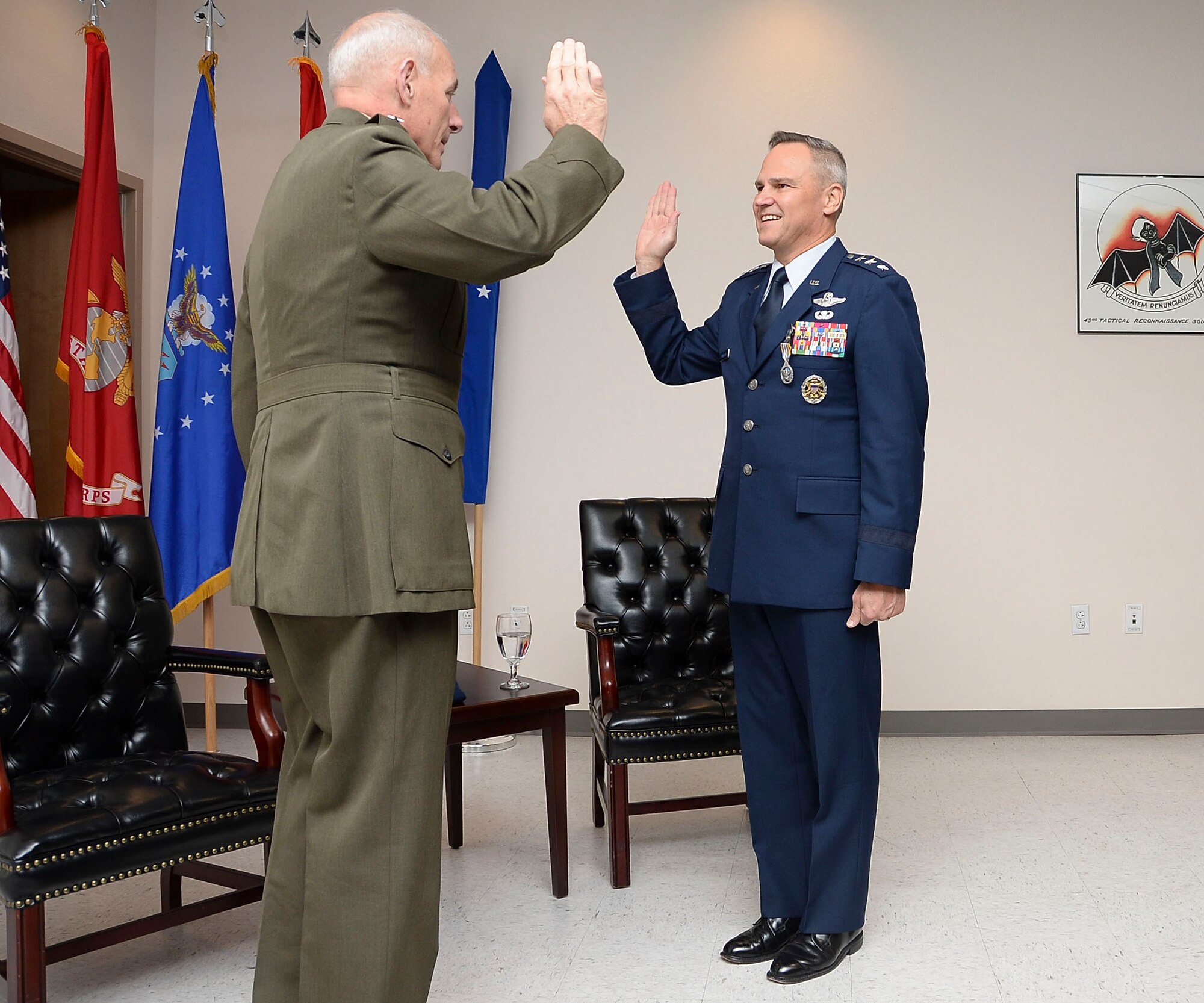 Gen. John Kelly, United States Southern Command Commander, administers the oath of office to Lt. Gen. Chris Nowland, 12th Air Force (Air Forces Southern) incoming commander, at Davis-Monthan AFB, Ariz., Dec. 19, 2014. Nowland comes to Tucson from his previous assignment as the Chief of Staff, Headquarters United States Southern Command, where he was responsible for successfully integrating and synchronizing the efforts of nine directorates and 16 special staff offices in support of the Combatant Commander's Theater Campaign Plan. (U.S. Air Force photo by Staff Sgt. Adam Grant/Released)