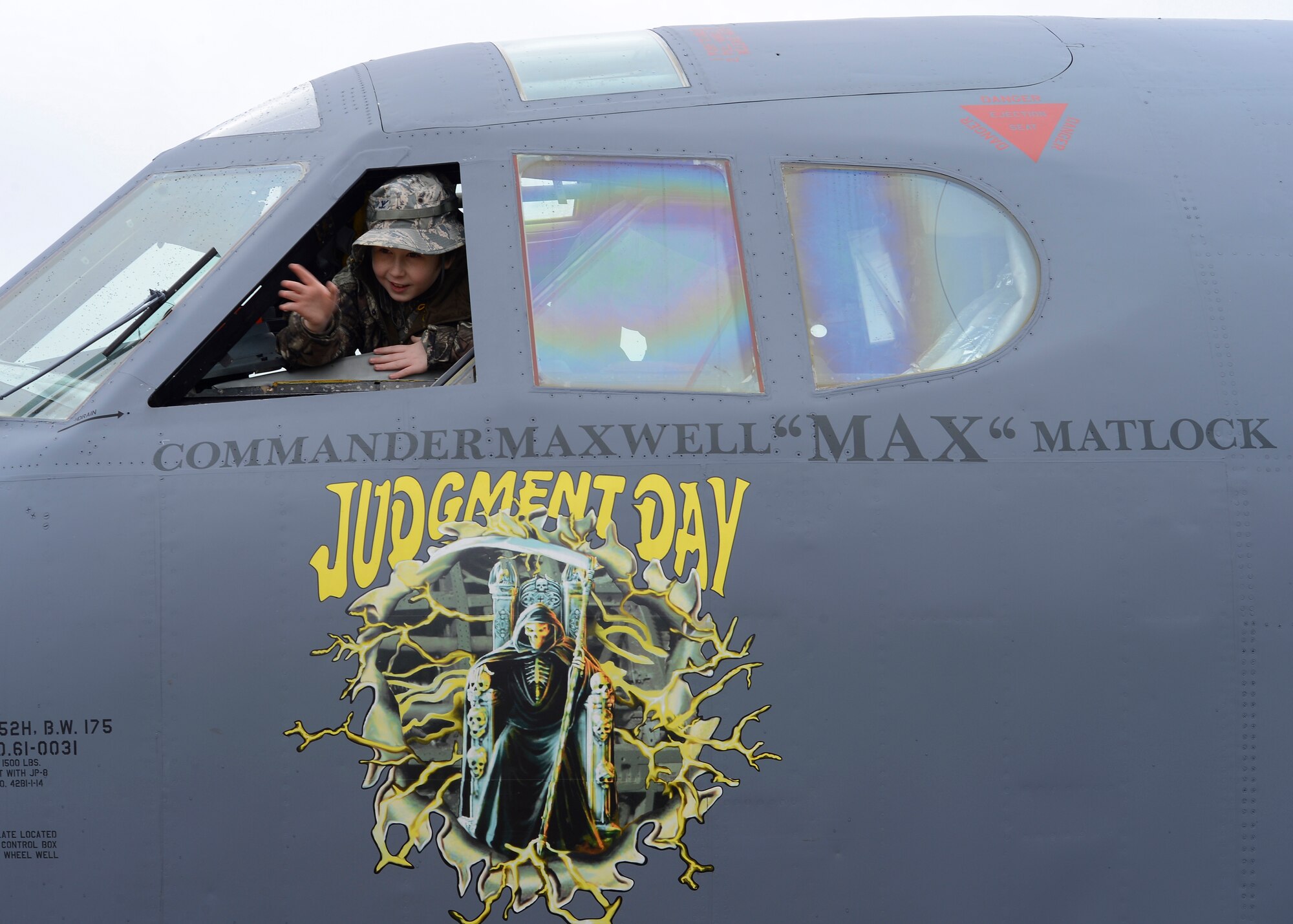 Maxwell Matlock, 10, waves from the cockpit of a B-52H Stratofortress on Barksdale Air Force Base, La., Dec. 18, 2014. Matlock was honored by having his name on a B-52 as part of a presentation for becoming an Honorary Crew Chief. (U.S. Air Force photo/Senior Airman Joseph A. Pagán Jr.)