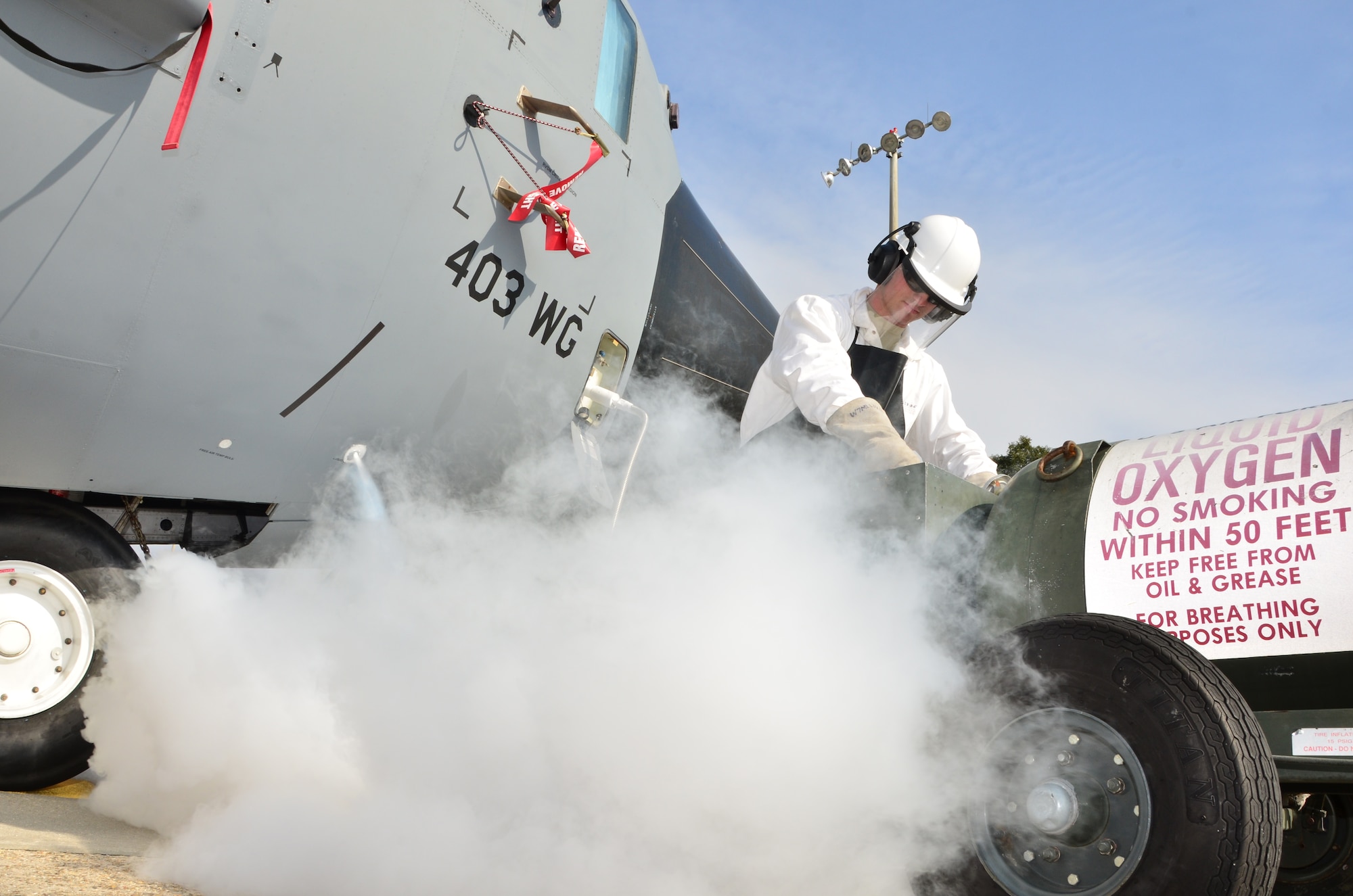 Airman 1st Class Christopher Townsley, a crew chief with the 403rd Maintenance Group, recharges a C-130J with liquid oxygen on the Keesler Air Force Base flight line Dec 14. (U.S. Air Force Photo/Master Sgt. Brian Lamar)