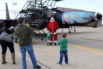 Santa Claus poses for a photo in front of a U-2 Dragon Lady during the Children's Holiday Party at Beale Air Force Base, Calif., Dec. 13, 2014. More than 1,000 members of Team Beale attended the event. (U.S. Air Force photo by Staff Sgt. Robert M. Trujillo/Released)