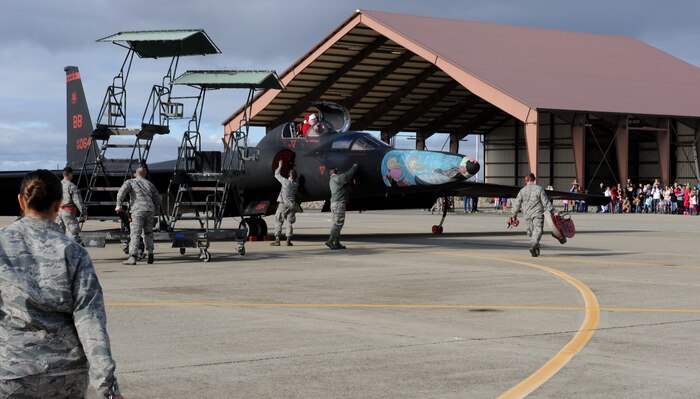 Santa Claus arrives via U-2 Dragon Lady during the annual Children's Holiday Party at Beale Air Force Base, Calif., Dec. 13, 2014. More than 1,000 members of Team Beale attended the event. (U.S. Air Force photo by Staff Sgt. Robert M. Trujillo/Released)