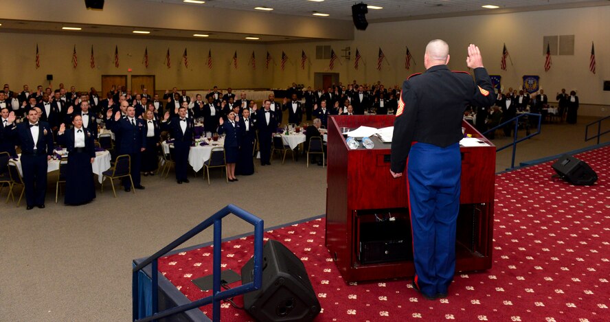 U.S. Marine Corps Sgt. Maj. Bryan Battaglia, Senior Enlisted Advisor to the Chairman of the Joint Chiefs of Staff, re-administers the oath of enlistment to NCOs and petty officers to renew their commitment to the profession of arms at Barksdale Air Force Base, La., Dec. 17, 2014. Battaglia was the guest speaker at the Joint Noncommissioned Officer Dining-In, which was the capstone event of a two-and-a-half-day seminar on professional development for NCOs and petty officers. (U.S. Air Force photo/Airman 1st Class Mozer O. Da Cunha)