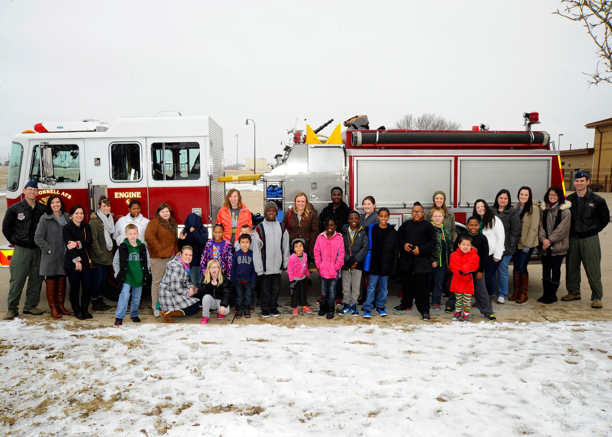 Members of the 349th Air Refueling Squadron pose with children and chaperones from Big Brothers Big Sisters Wichita, Dec. 19, 2014, at McConnell Air Force Base, Kan. The squadron hosted 20 children onto the installation as part of their annual Operation Santa, where they provide a safe holiday setting for less fortunate kids. (U.S. Air Force photo/Senior Airman Victor J. Caputo)