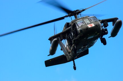 A UH-60 Black Hawk helicopter from the 1-228th Aviation Battalion circles around an area of Lake Yojoa looking for a rescue mannequin, Honduras, Dec. 18, 2014.   The 1-228th AVN BN spent the afternoon practicing overwater hoist training.  The overwater hoist training was held to ensure members of Joint Task Force-Bravo are planning and preparing for crisis and contingency response as part of U.S. Southern Command’s mission. Contingency planning prepares the command for various scenarios that pose the greatest probability of challenging our regional partners or threatening our national interests.  (U.S. Air Force photo/Tech. Sgt. Heather Redman)
