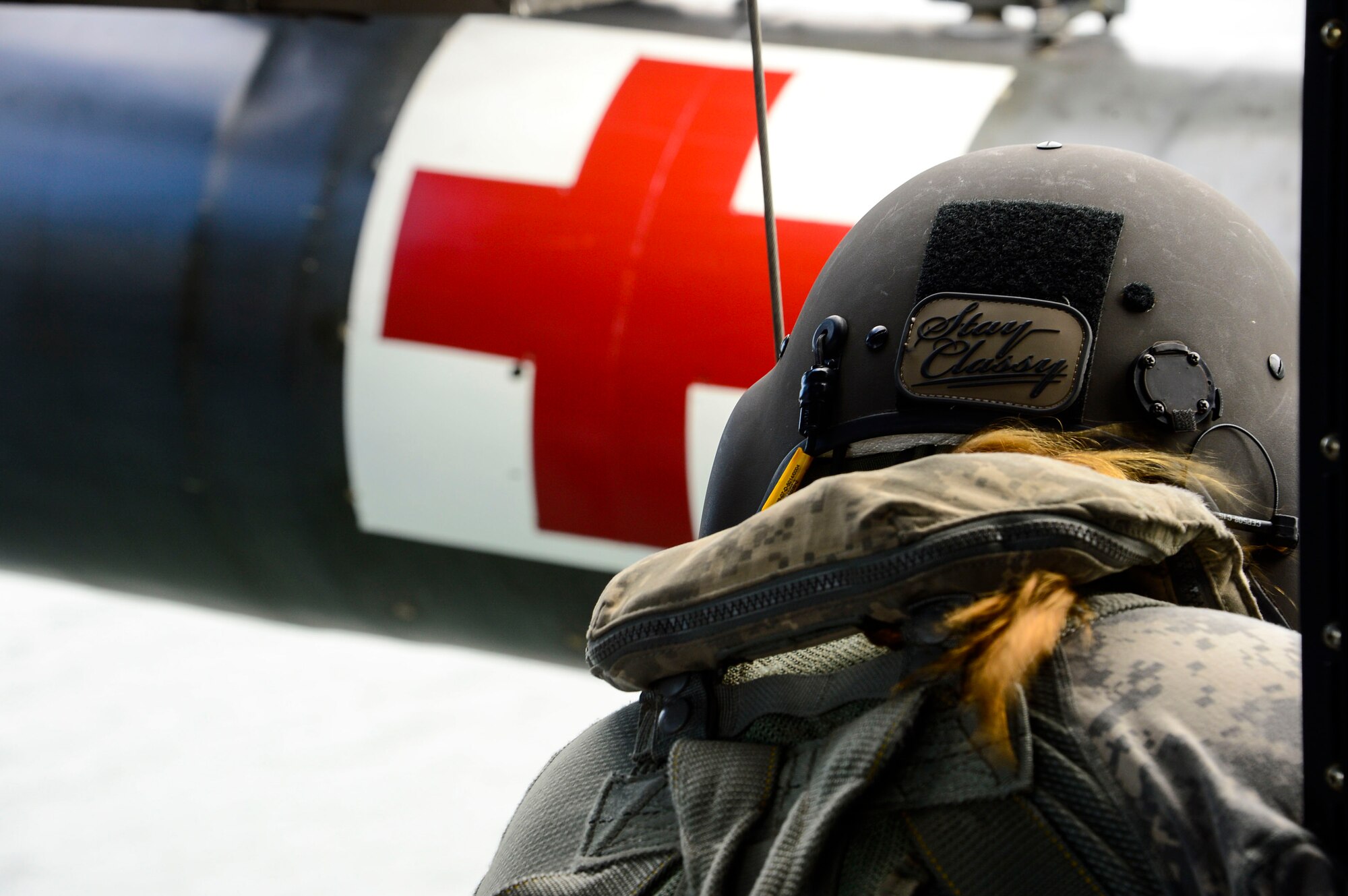 U.S. Army Sgt. Kelly Teschner, 1-228th Aviation Battalion crew chief lowers a medic into Lake Yojoa to retrieve a rescue mannequin, Honduras, Dec. 18, 2014.   The 1-228th AVN BN spent the afternoon practicing overwater hoist training.  The overwater hoist training was held to ensure members of Joint Task Force-Bravo are planning and preparing for crisis and contingency response as part of U.S. Southern Command’s mission. Contingency planning prepares the command for various scenarios that pose the greatest probability of challenging our regional partners or threatening our national interests.  (U.S. Air Force photo/Tech. Sgt. Heather Redman)