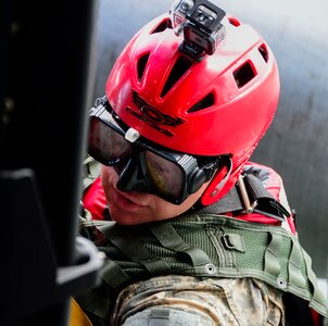 A medic from the 1-228th Aviation Battalion climbs in to a UH-60 Black Hawk helicopter after being lowered to retrieve a rescue mannequin in Lake Yojoa, Honduras, Dec. 18, 2014.   The 1-228th AVN BN spent the afternoon practicing overwater hoist training.  The overwater hoist training was held to ensure members of Joint Task Force-Bravo are planning and preparing for crisis and contingency response as part of U.S. Southern Command’s mission. Contingency planning prepares the command for various scenarios that pose the greatest probability of challenging our regional partners or threatening our national interests.  (U.S. Air Force photo/Tech. Sgt. Heather Redman)