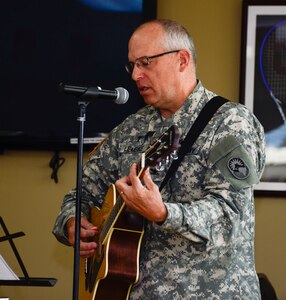 U.S. Army Col. Michael Lembke, U.S. Southern Command chaplain plays the guitar and sings during the December Prayer Breakfast at the Dining Facility, on Soto Cano Air Base, Honduras, Dec. 18, 2014.  (U.S. Air Force photo/Tech. Sgt. Heather Redman)