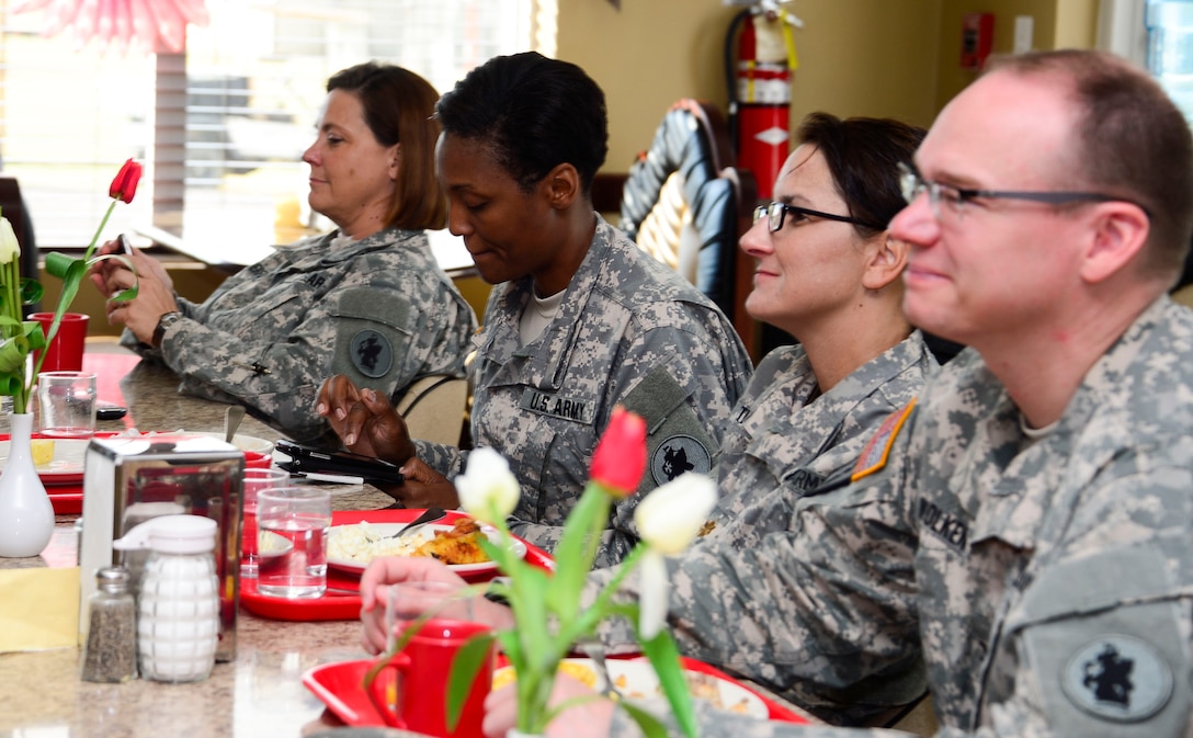 Members of Joint Task Force-Bravo’s Medical Element eat breakfast and listen to U.S. Army Col. Michael Lembke, U.S. Southern Command chaplain’s message during the December Prayer Breakfast at the Dining Facility, on Soto Cano Air Base, Honduras, Dec. 18, 2014.  (U.S. Air Force photo/Tech. Sgt. Heather Redman)