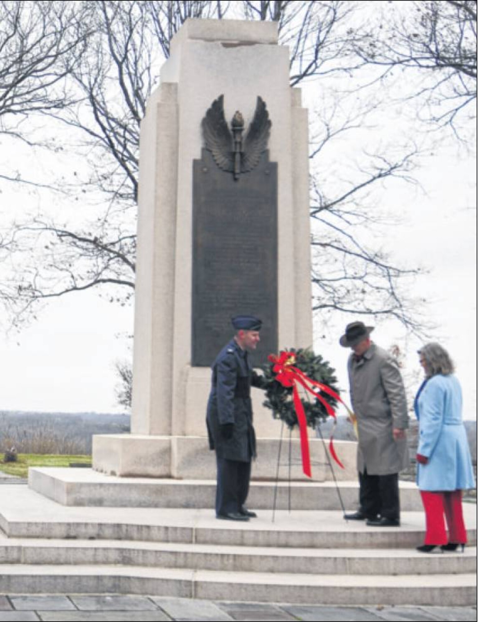 (Left to right) Col. John Devillier, 88th Air Base Wing commander; Stephen Wright and Amanda Wright Lane, the great-grandnephew and great-grandniece of the Wright brothers, joined together the morning of Dec. 17 to lay a wreath commemorating the 111th anniversary of practical powered flight on the Wright Memorial Hill near the base's Area B. (Skywrighter photo by James Tyler)
