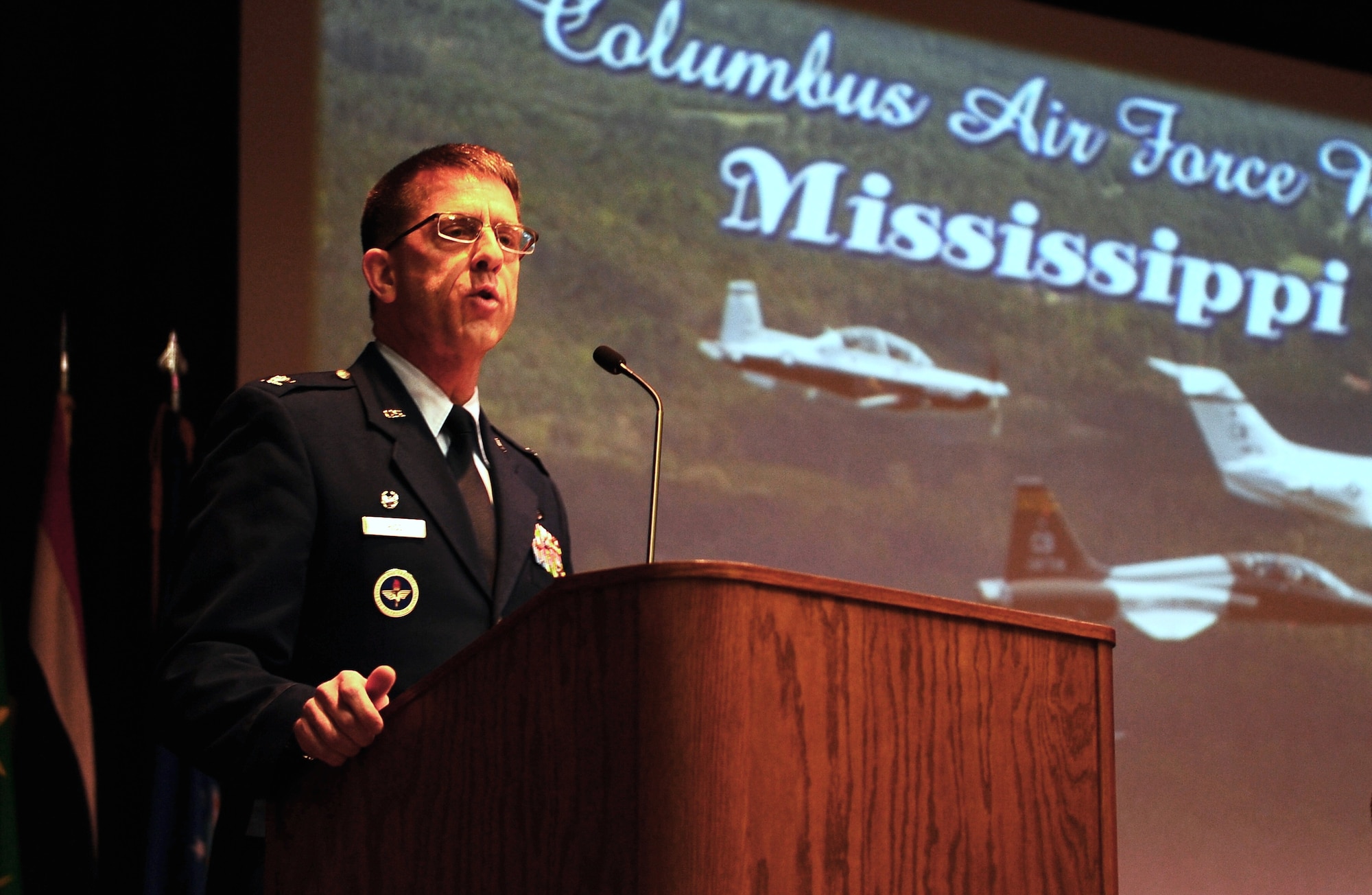 Col. Steven Hiss, Commander of Air Force Reserve Officer Training Corps Detachment 890 at the University of Virginia in Charlottesville, speaks to Specialized Undergraduate Pilot Training Class 15-03 during their graduation ceremony Dec. 12 in the Kaye Auditorium at Columbus Air Force Base. Hiss included what it means to be an officer, the importance of training seriously and how all Airmen contribute to the fight in his speech. (U.S. Air Force photo/Airman Daniel Lile)