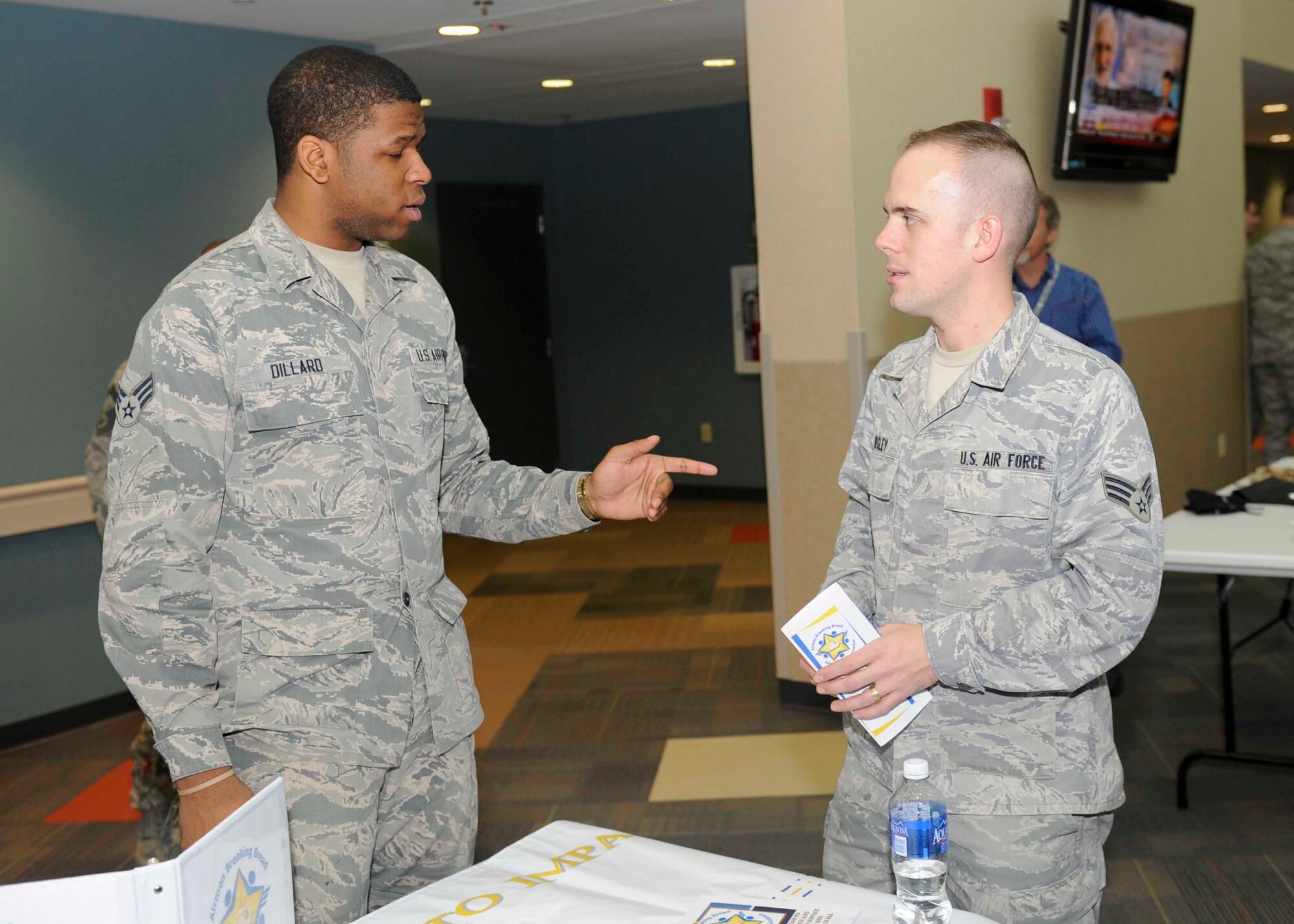 WRIGHT-PATTERSON AIR FORCE BASE, Ohio -- Senior Airmen Nathen Dillard and Daniel Begley, members of the National Air and Space Intelligence Center, speak about the Airmen Breaking Bread organization during NASIC's Professional Club Recruitment Day here, Dec. 17. During the event representatives were able to speak with Airmen about their respective organizations, and, if interested, Airmen were given membership opportunities. The recruitment day was held to show how important these organizations are to the professional development of Airmen. (U.S. Air Force photo by Airmen 1st Class Samuel Earick)