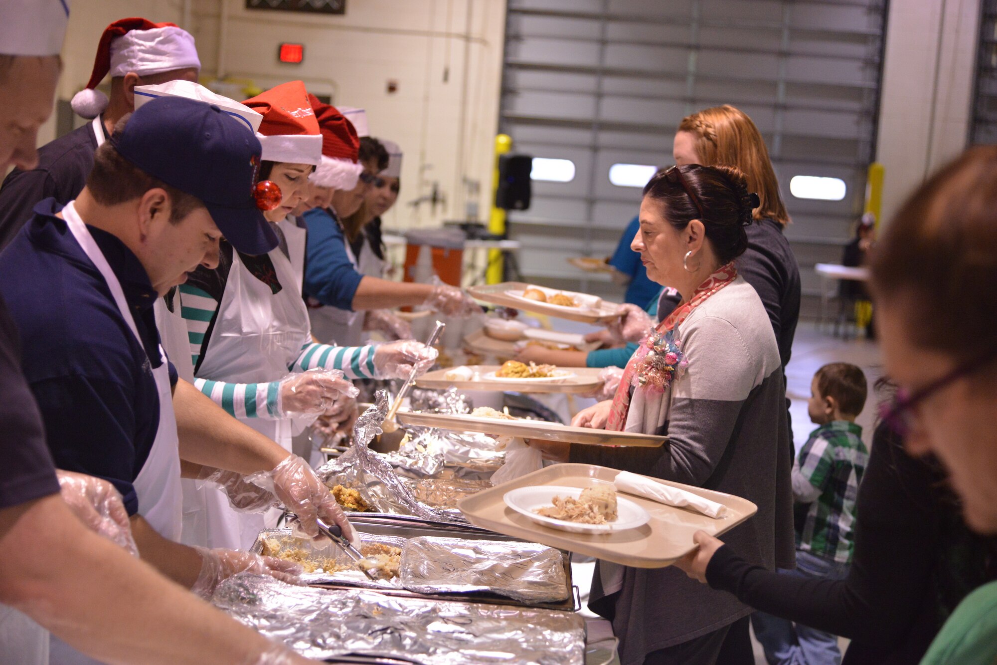 Lunch was served to about 2,000 people from local communities at the Operation Holiday Cheer event Dec. 17. In addition to the feast, more than 800 toys were given to kids.  Operation Holiday Cheer is sponsored by the Kirtland Fire Department and is one of the base's biggest charity events of the year. (Photo by Todd Berenger)