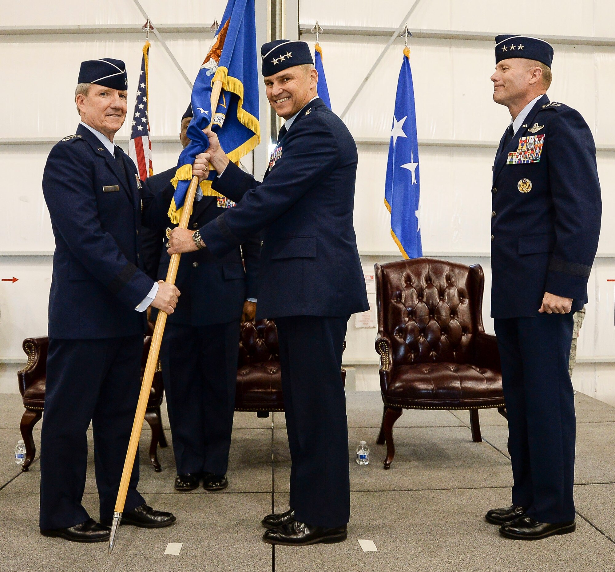 Gen. Hawk Carlise, Air Combat Command Commander, passes the 12th Air Force (Air Forces Southern) guidon to Lt. Gen. Chris Nowland, 12th Air Force (Air Forces Southern) Commander, as he assumes command during a ceremony at Davis-Monthan AFB, Ariz., Dec. 19, 2014. The passing of the guidon marks the beginning of Nowland’s tour as commander of 12th Air Force (Air Forces Southern). (U.S. Air Force photo by Staff Sgt. Adam Grant/Released)