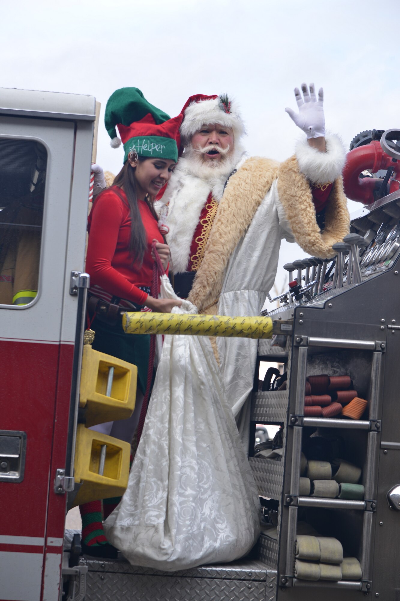 Santa Claus arrives on a fire engine at the Operation Holiday Cheer event Dec. 17.  About 2,000 people were fed and more than 800 toys were given to kids from nearby  communities.  Operation Holiday Cheer is sponsored by the Kirtland Fire Department and is one of the base's biggest charity events of the year. (Photo by Todd Berenger)