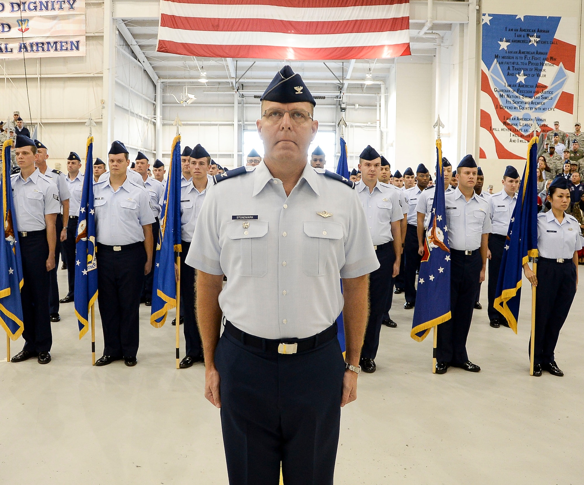 Airmen assigned to 12th Air Force (Air Forces Southern) stand at the position of attention while awaiting the arrival of the official party during the 12th Air Force (Air Forces Southern) change of command ceremony on Davis-Monthan AFB, Ariz., Dec. 19, 2014. Lt. Gen. Tod Wolters relinquished command to Lt. Gen. Chris Nowland. (U.S. Air Force photo by Staff Sgt. Adam Grant/Released)