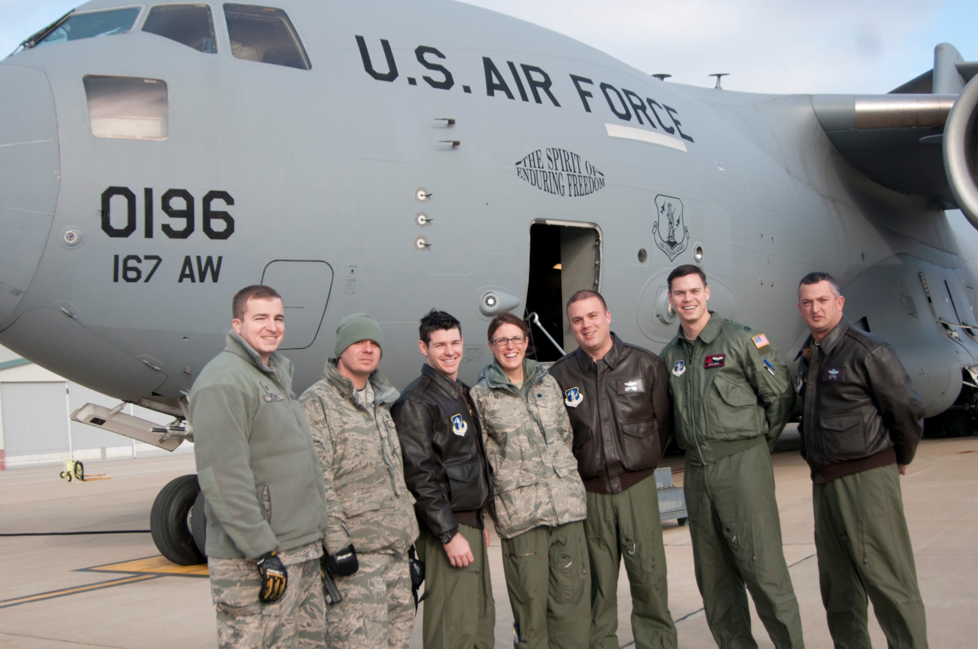 After the first local training sortie of a C-17 at the 167th Airlift Wing, West Virginia Air National Guard base in Martinsburg, W.Va., Dec. 18, ground crew and those aboard the historic flight stand in front of the aircraft. From left to right: Staff Sgt. Mark A. Kelley Jr., Master Sgt. Joseph S. Bosacco, Capt. Justin S. McCabe, Lt. Col. Lisa Windle, Master Sgt. Charles R.D. Moore Capt. Christopher K. Nary and Chief Master Sgt. Leslie Y. Morris.  (Air National Guard photo by Staff Sgt. Sherree Grebenstein/released)