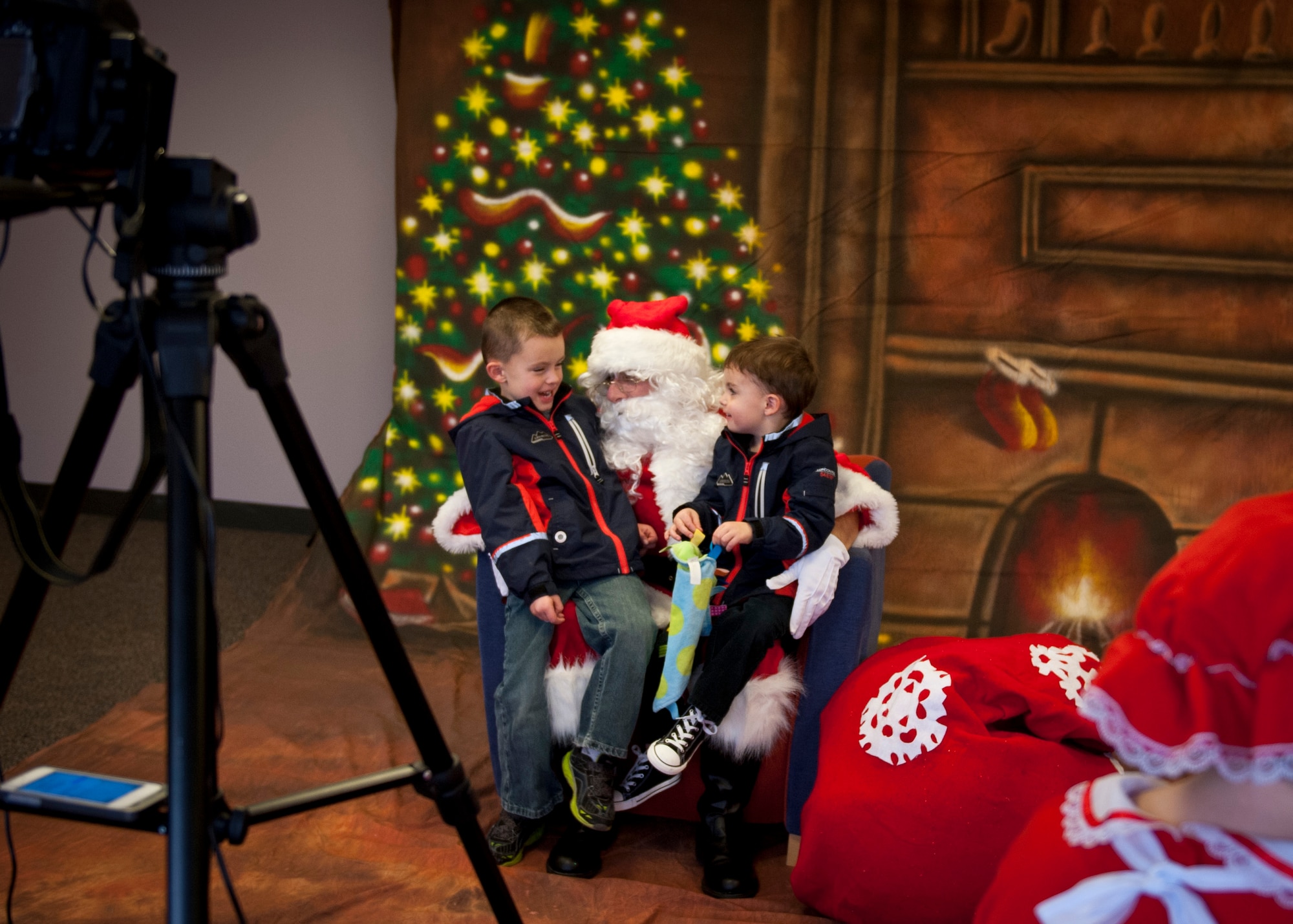 PETERSON AIR FORCE BASE, Colo. – Jack Cadavero, 5, left, and his brother Brett chat with Santa after getting their photo taken at the Winter Wonderland event held at the R. P. Lee Youth Center, Dec. 13, 2014. The second annual Winter Wonderland was held to celebrate the beginning of the winter season and the holidays with crafts, face painting, snacks, Santa and much more. Admission was $5 plus a non-perishable food item or something for a pet, which the Boys and Girls Club Keystone Club will be donating to local needy families. (U.S. Air Force photo by Airman 1st Class Rose Gudex)