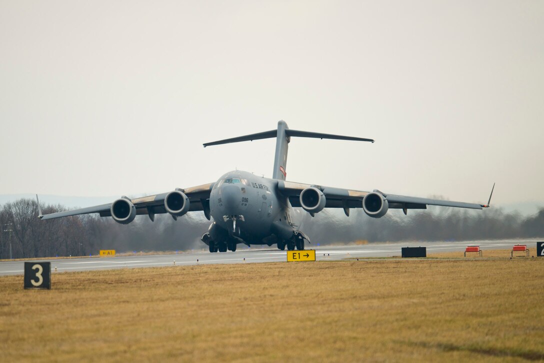 The front wheels of a C-17 Globemaster III lift off the runway at the 167th Airlift Wing, West Virginia Air National Guard base in Martinsburg, W.Va., Dec. 18. This marked the first launch, a local training sortie, for the wing that is currently in conversion from the C-5 Galaxy to the C-17. The unit received its first C-17 aircraft Sept. 25. (Air National Guard photo by Master Sgt. Emily Beightol-Deyerle/released)