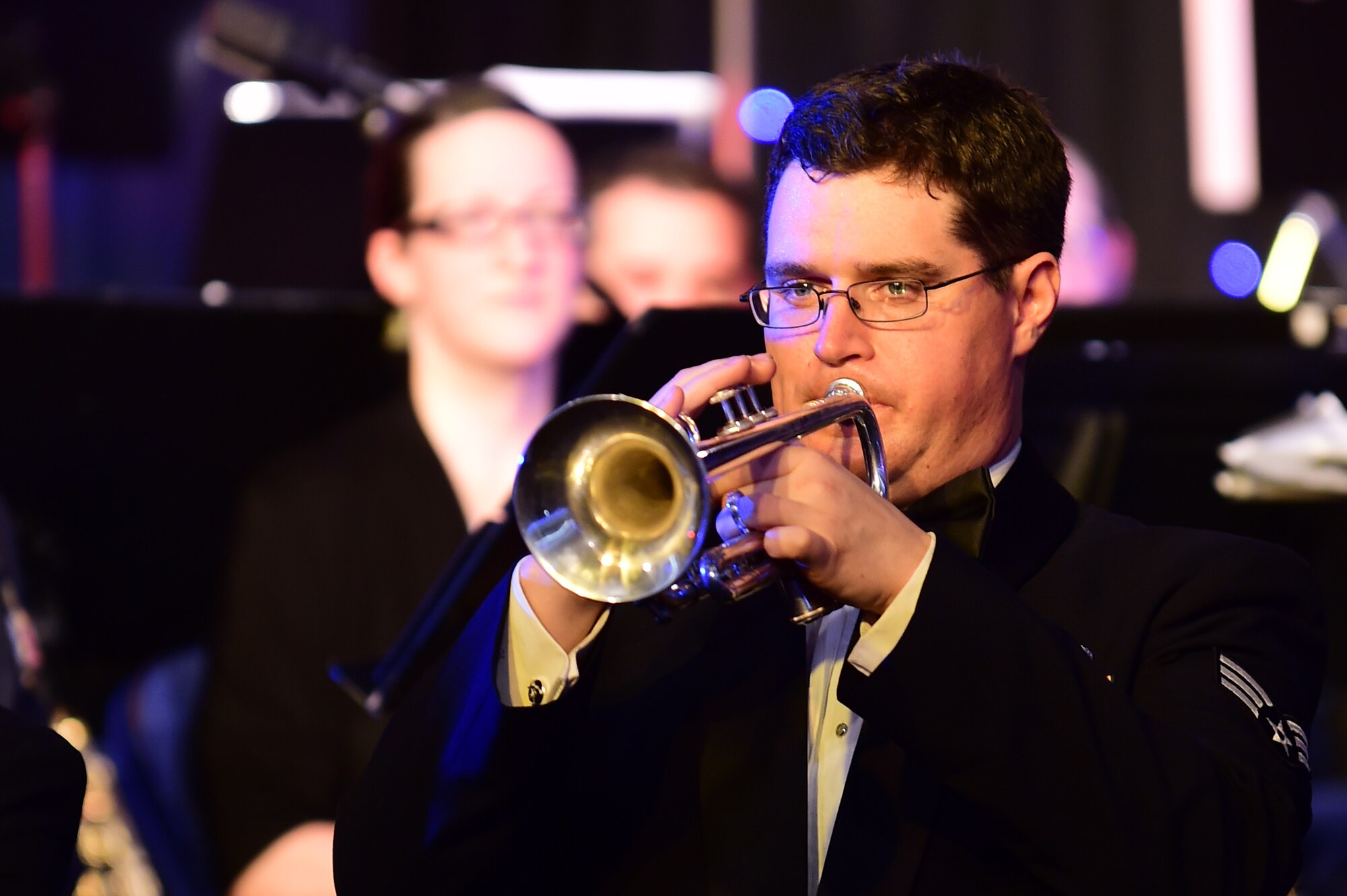 Senior Airman Will McCrary plays a trumpet solo, during the U.S. Air Forces in Europe Concert band holiday celebration at Burgess Hall in St. Ives, Cambridgeshire, England, Dec. 18, 2014. (U.S. Air Force photo by Tech. Sgt. Chrissy Best)